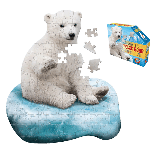 Madd Capp I Am Lil' Polar Bear 100-piece shaped jigsaw puzzle showing white polar bear sitting on blue ice floe, with loose puzzle pieces and product box displa