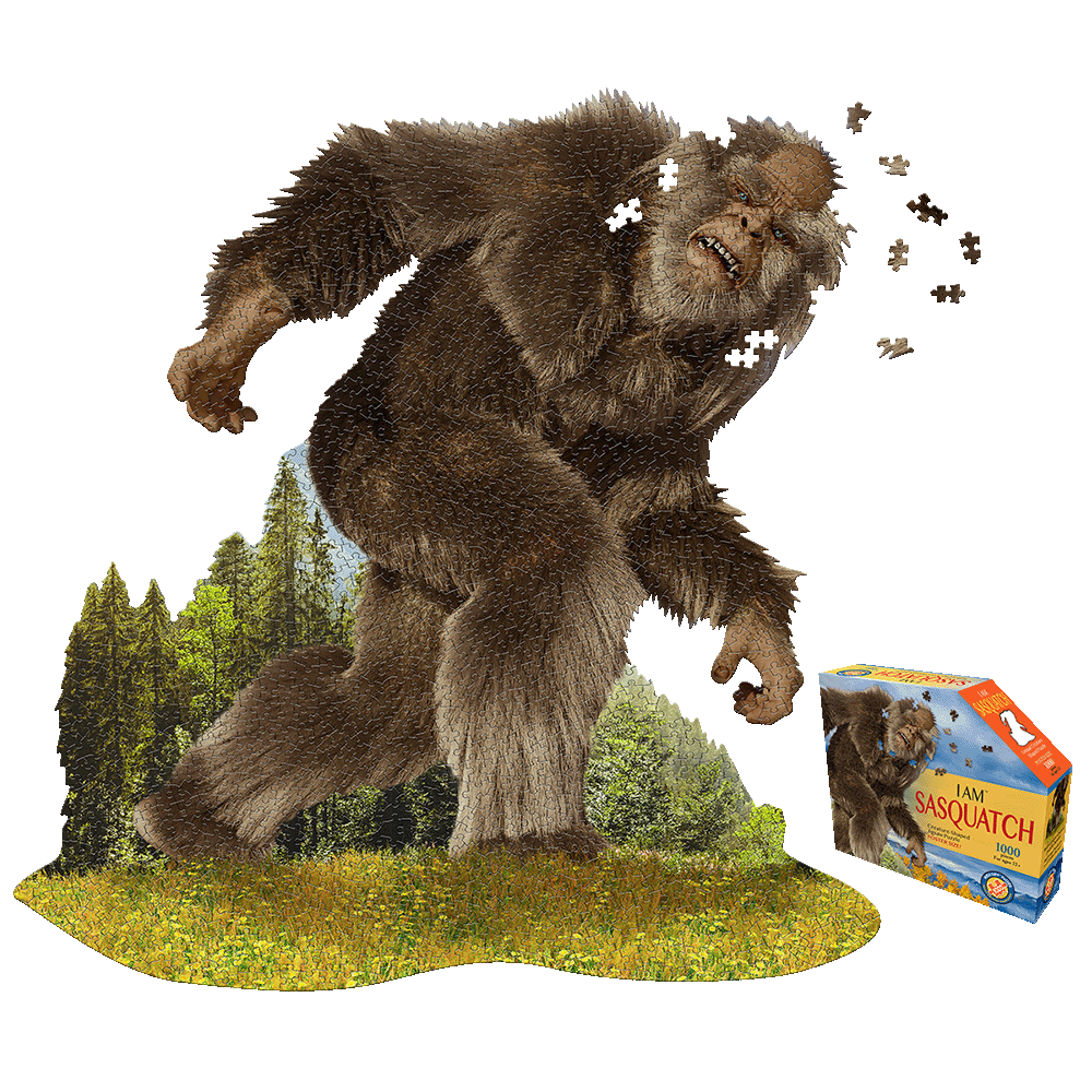 Madd Capp Sasquatch Shaped Jigsaw Puzzle box and completed puzzle showing a large brown Sasquatch in a forest landscape with scattered puzzle pieces