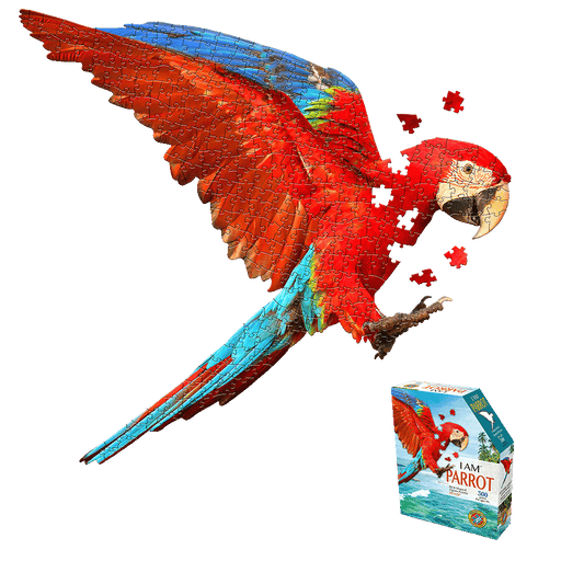 Red and blue parrot-shaped jigsaw puzzle with loose pieces scattered, shown next to product box labeled 'I AM Parrot 300 pieces'
