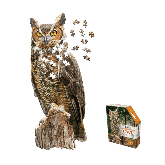 Great Horned Owl jigsaw puzzle showing assembled owl perched on tree stump with loose puzzle pieces floating, next to product box