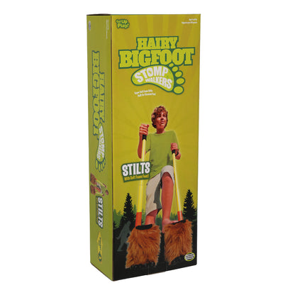 Hairy Bigfoot Stomp Walkers stilts with soft foam feet, modeled by a child in yellow shirt on forest background