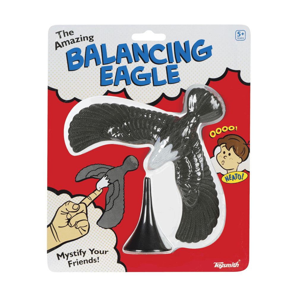 The Amazing Balancing Eagle packaging, showing black and white eagle figure balanced on cone stand with hand holding smaller eagle piece, red background, age 5+