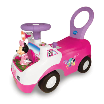 Pink and white Disney Minnie Mouse ride-on toy with purple handle, light-up features, black wheels, and interactive activity panel