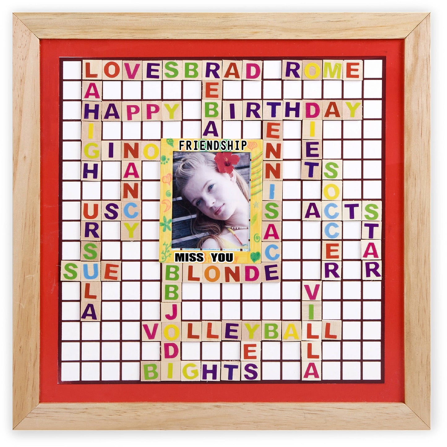 Framed memory board with wooden border and red backing featuring colorful letter tiles arranged in a crossword pattern with phrases like "LOVE," "BRAD," "ROME,"