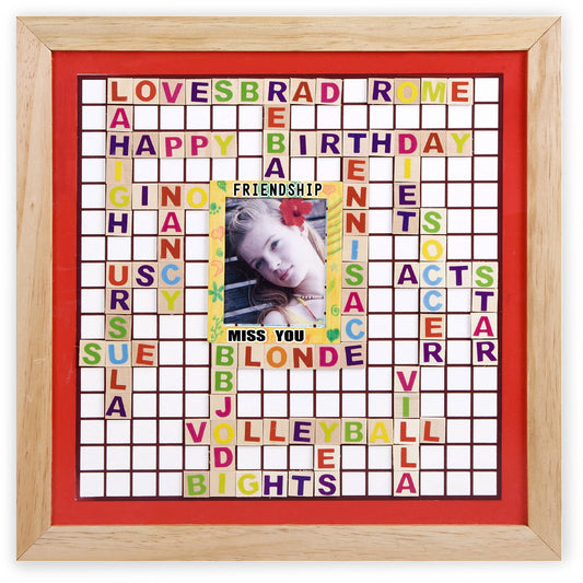 Framed memory board with wooden border and red backing featuring colorful letter tiles arranged in a crossword pattern with phrases like "LOVE," "BRAD," "ROME,"