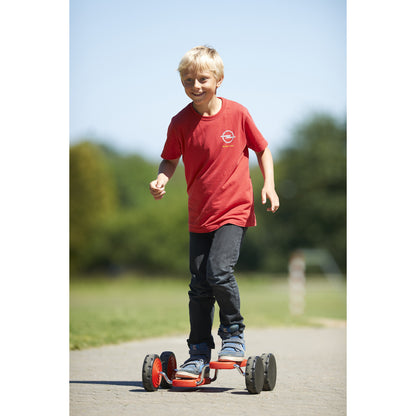 Child riding red GONGE Go Go Roller on outdoor path