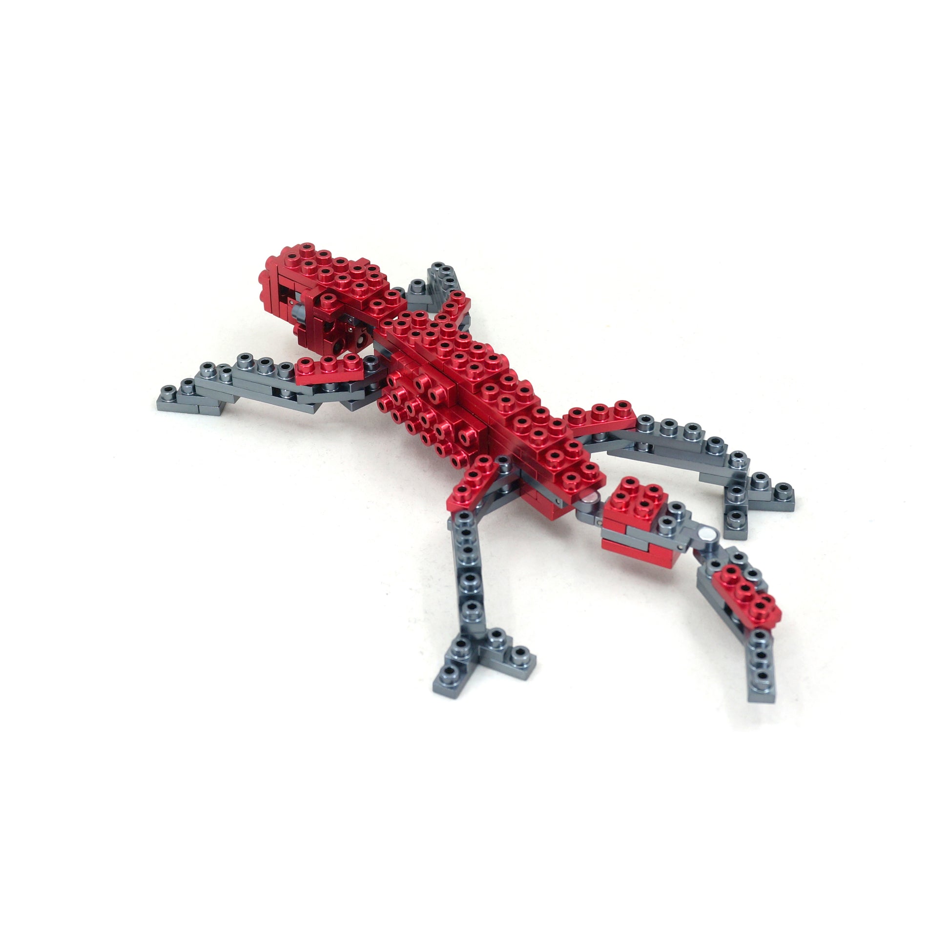 Red and gray building blocks assembled into a butterfly shape with articulated wings and legs on plain background