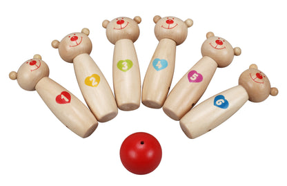 Six wooden bowling pins with smiling bear heads and numbered bodies, arranged in a circle around a red bowling ball