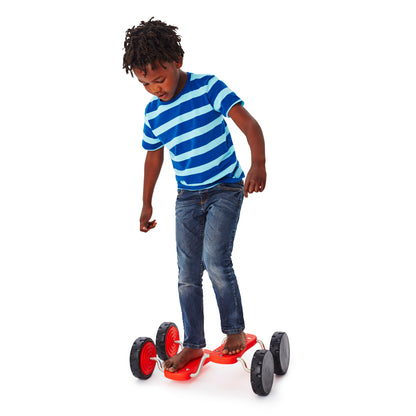 GONGE Go Go Roller red ride-on toy with black wheels, child in blue striped shirt