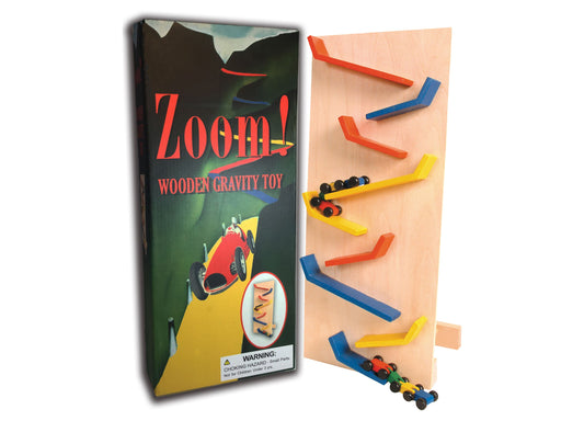 Zoom! Wooden Gravity Toy with wooden track pieces in red, blue, and yellow, and small colorful cars at bottom. Package shown on left with warning label.