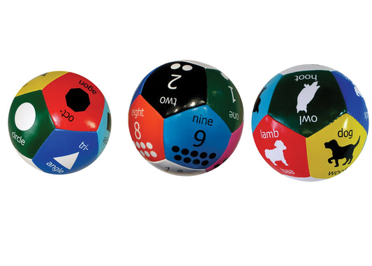 Three colorful fabric Thumball balls with shapes, numbers, and animal icons printed on hexagonal panels