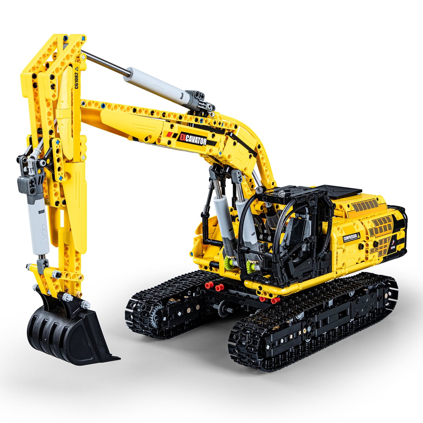 Yellow and black CaDA Engineering Series excavator building set with articulated arm, bucket attachment, and tracked treads on plain background