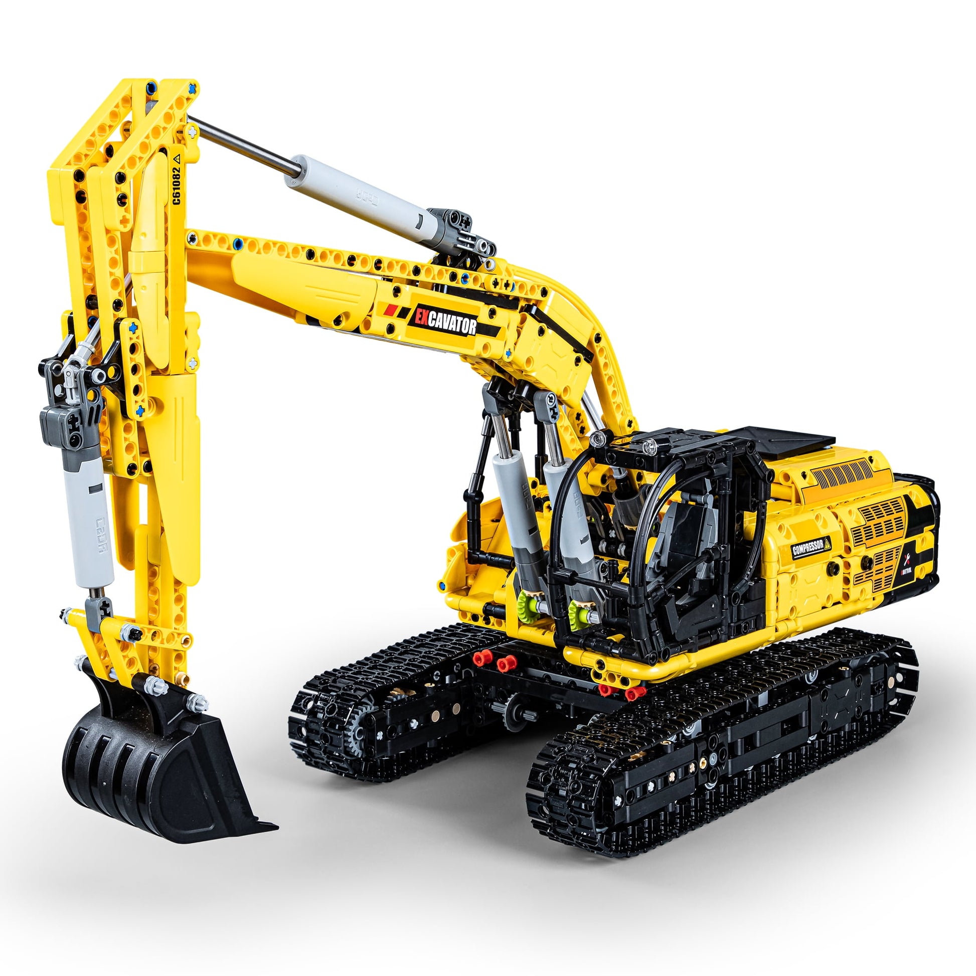 Yellow and black CaDA Engineering Series excavator building set with articulated arm, bucket attachment, and tracked treads on plain background