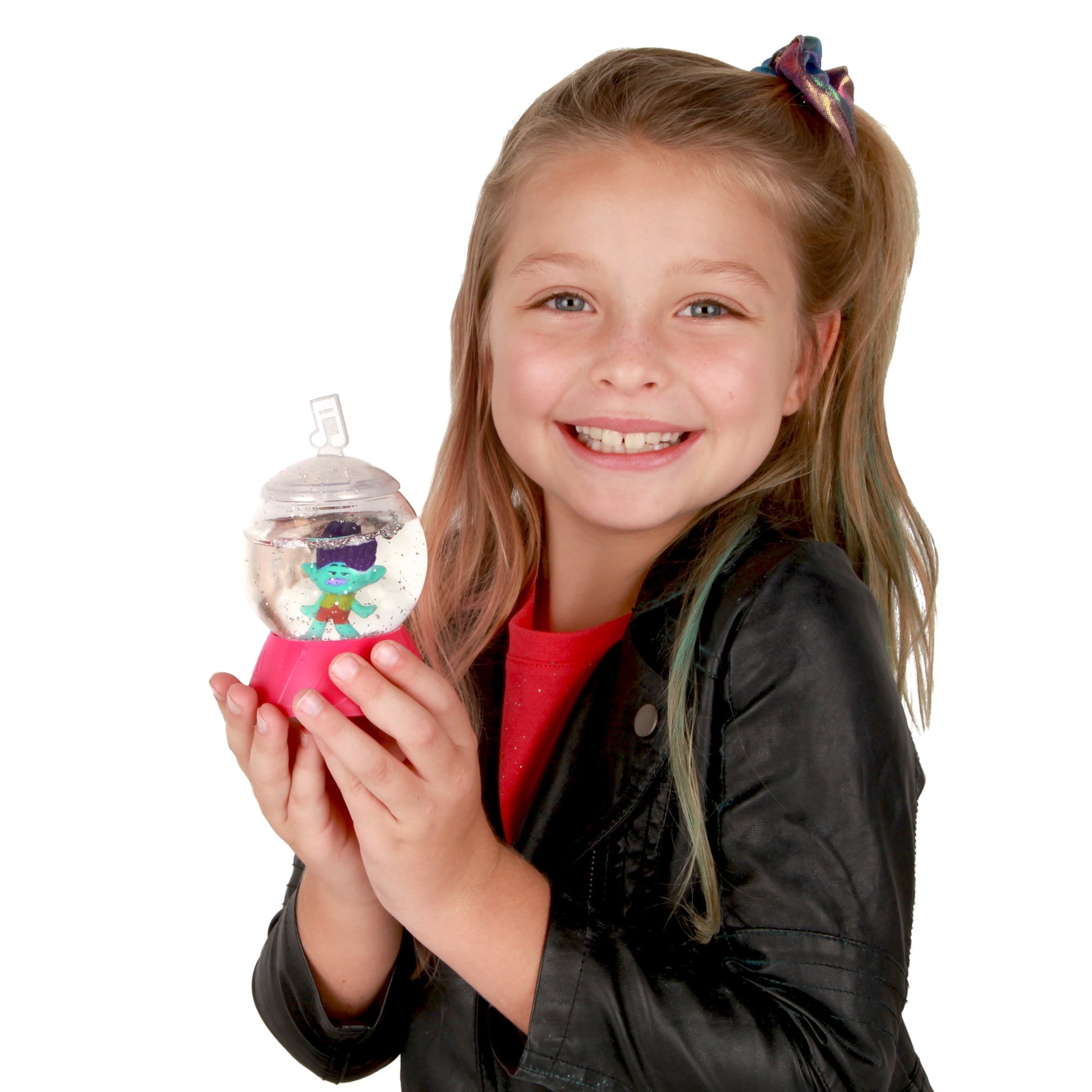 Child modeled holding Trolls World Tour Sparkle Dome Surprise toy with colorful character inside clear dome and pink base
