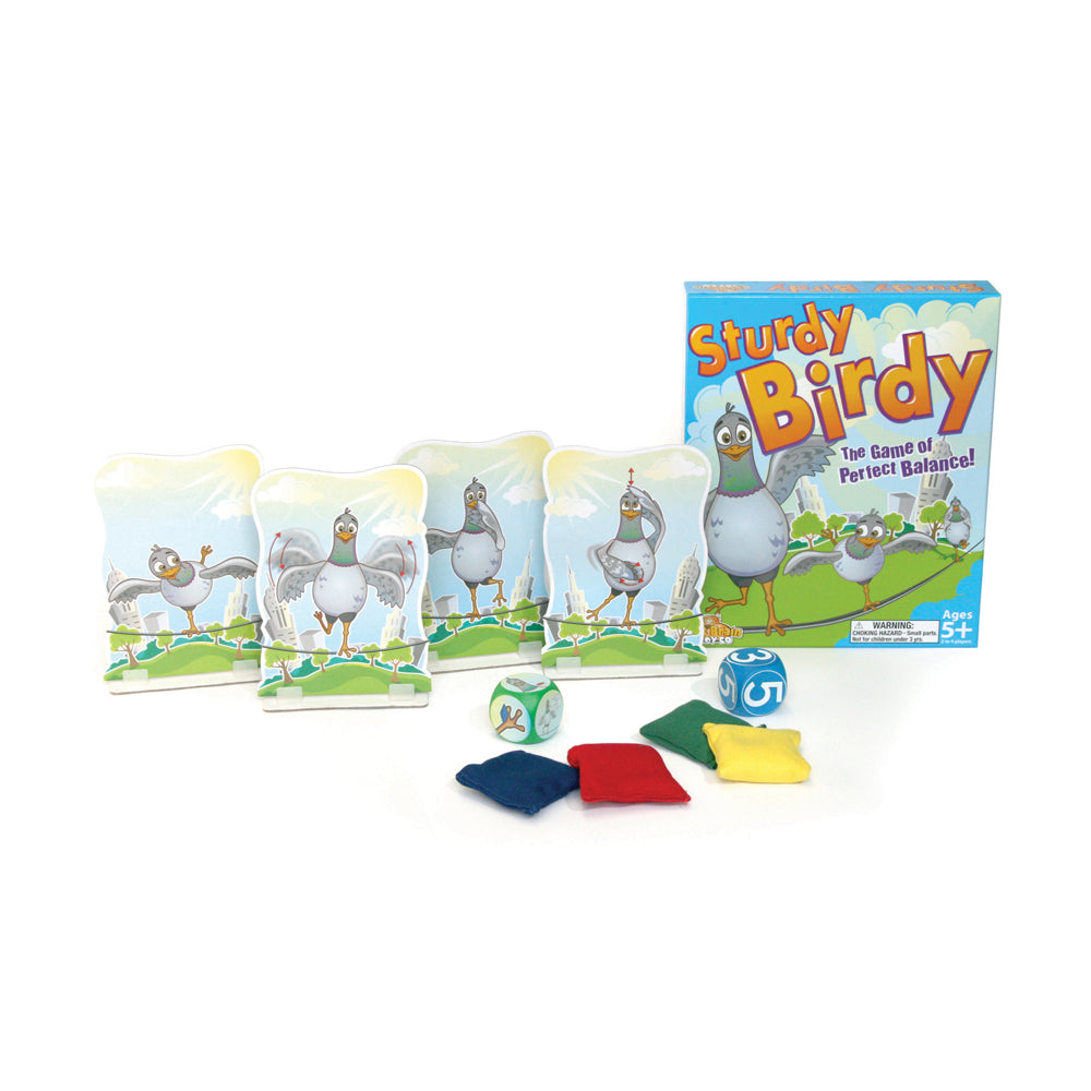 Sturdy Birdy balance game showing bird figurines on a perch, colorful fabric weights, die, and game box with sky and grass background