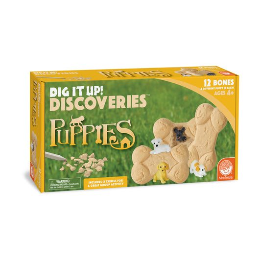 Dig It Up! Discoveries Puppies excavation kit box showing tan bone-shaped mold with embedded puppy figures and chisels for digging out 12 different puppies