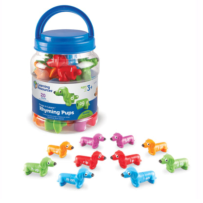 Snap-n-Learn Rhyming Pups set with blue carry bucket containing 20 colorful dog-shaped pieces labeled with rhyming words, displayed with individual pieces shown