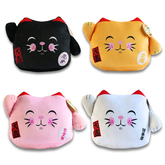 Four plush Maneki Neko lucky cat cushions in black, golden yellow, pink, and white with red ears, closed eyes, pink cheeks, and Chinese characters on tags