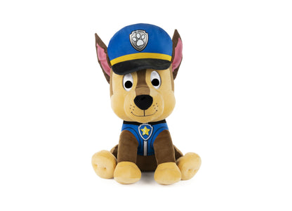 Chase police dog plush with tan and brown fur, blue police uniform, blue cap with paw badge, and pink inner ears, sitting upright