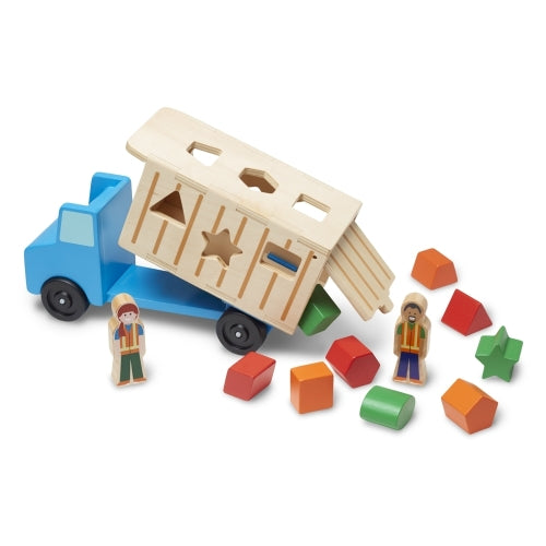Dump Truck toy with blue cab, beige dump bed, two worker figures, and colorful geometric shapes