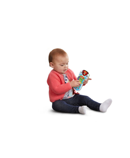 Baby playing with LeapFrog Scout's Learning Lights Remote in pink, blue, and colorful design