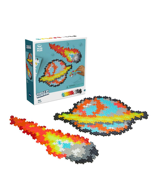 Plus-Plus Puzzle By Number space-themed building set with colorful pixel art comet and planet pieces assembled and in box