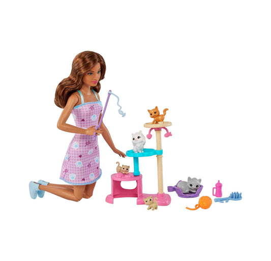 Barbie doll modeled by a child in pink checkered dress with fishing rod, standing beside cat tree playset with multiple small cat figurines and accessories