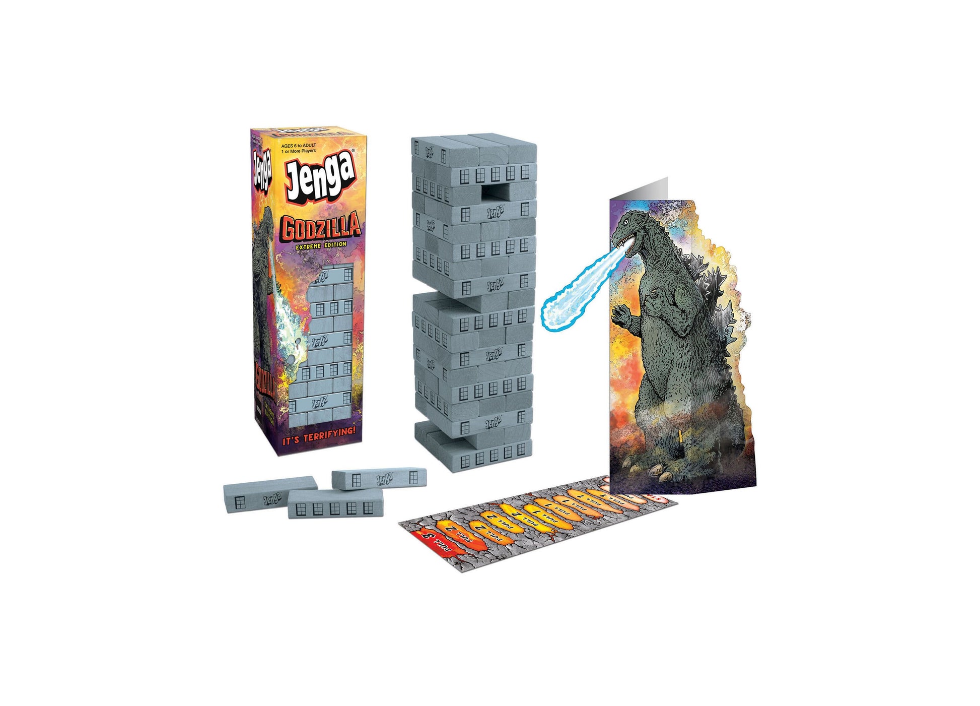 Jenga Godzilla Extreme Edition game set with stacked building blocks, Godzilla figure with light-up features, game board, and instruction cards on plain backgro