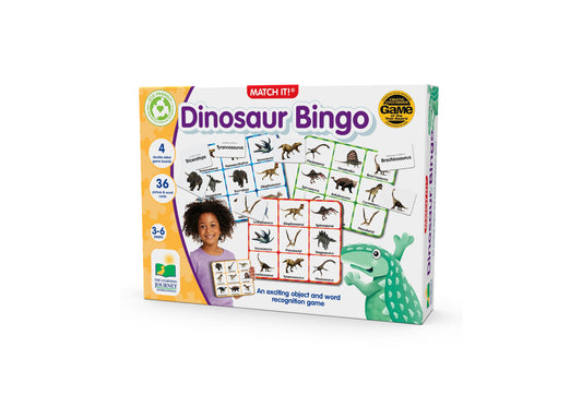 Match It! Dinosaur Bingo game box showing bingo cards with dinosaur illustrations, modeled by a child in purple shirt, with green dinosaur mascot and game piece