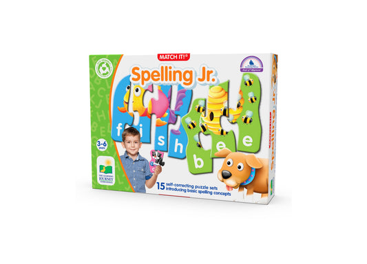 Match It! Spelling Jr. puzzle game box showing colorful letter tiles, a child on model holding game pieces, bees and bird graphics, and an orange dog character,
