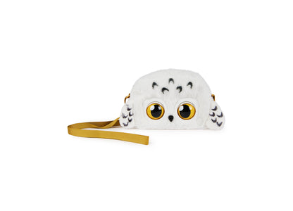 White plush owl purse pet with large golden yellow eyes, black feather markings, and gold shoulder strap