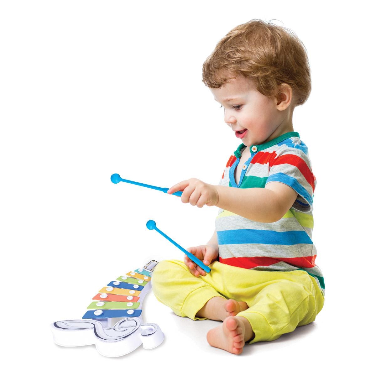 Toddler on model playing colorful xylophone with blue mallets, wearing striped shirt and yellow pants