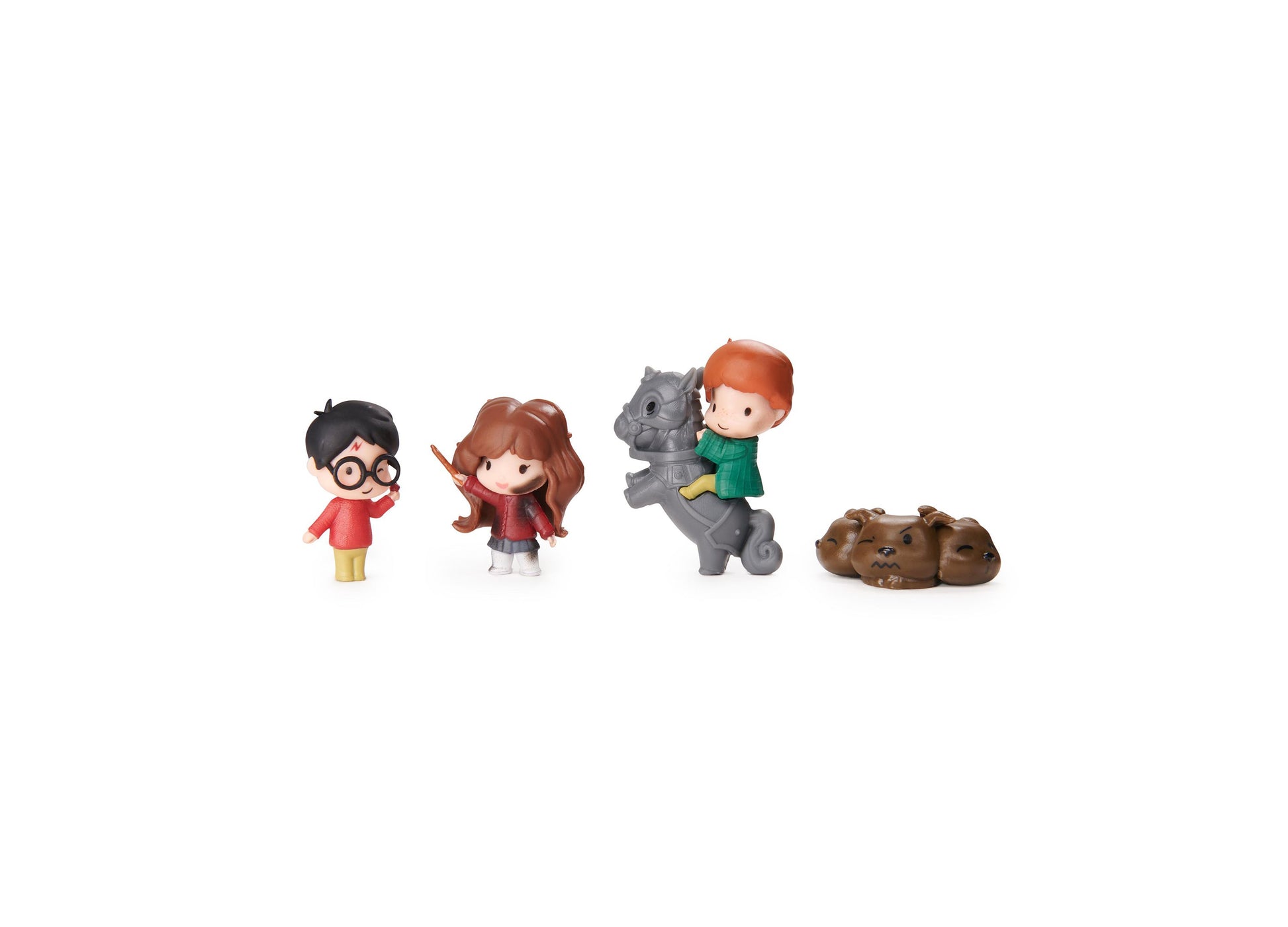 Four small wizard figurines including boy with black hair and glasses in red shirt, girl with brown hair in red outfit, boy with orange hair in green shirt on g