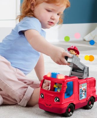 Red fire engine toy with child playing, bright red color and sturdy design
