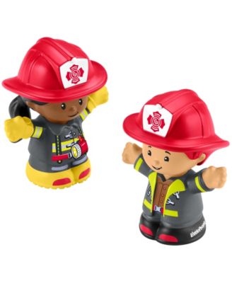 Two firefighter figurines wearing red helmets and yellow gear next to Toys R Us Gigantic Fire Engine Playset