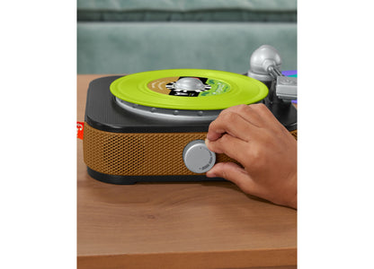 Fisher-Price Rockin' Record Player with bright lime-green record on turntable and tan storage base