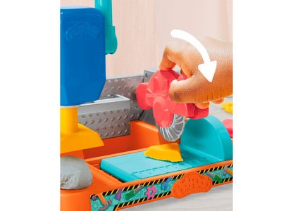 Play-Doh Stamp N Saw Tool Bench set with child's hand using red stamper tool on colorful orange, blue, and teal workb...