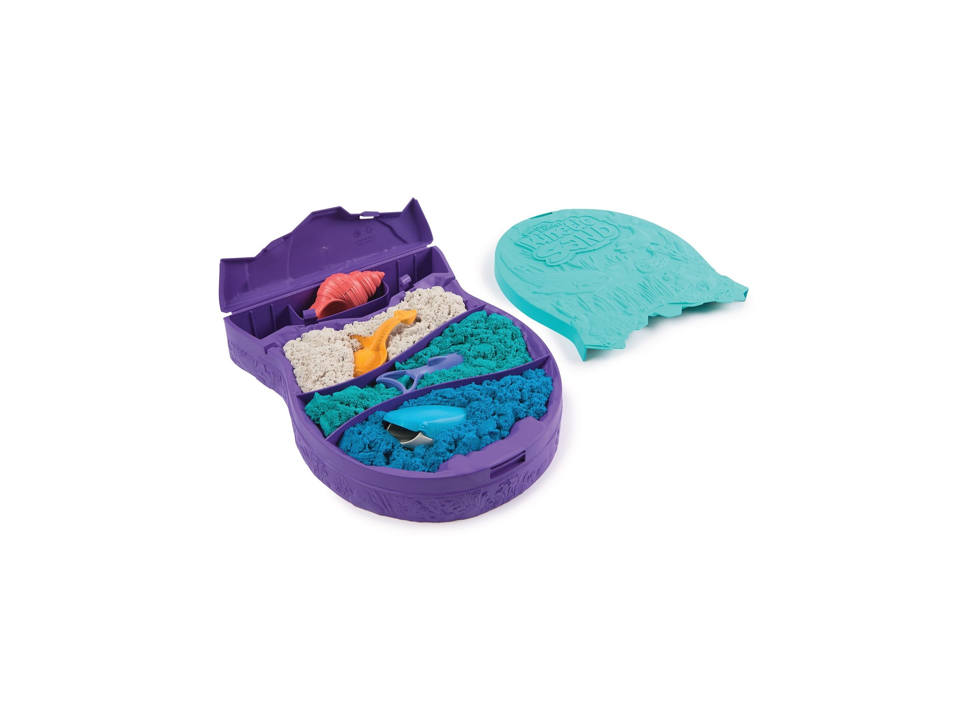 Purple whale-shaped container filled with turquoise and blue kinetic sand, small tools, and accessories; turquoise whale-shaped lid shown separately