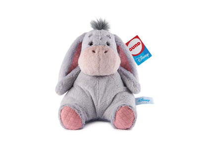 Gray plush Eeyore donkey with pink quilted paw pads and inner ears, dark spiky hair, and attached Disney and Gund tags, on plain white background