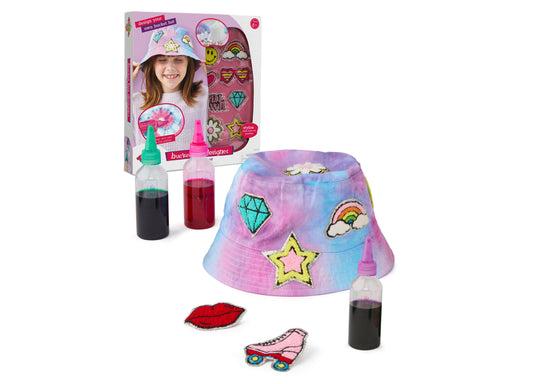 Tie dye bucket hat creation kit with pink and blue hat, decorative patches including stars and diamonds, fabric paint bottles, and applicator tools, modeled by
