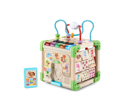 Wooden activity cube with colorful bead maze, number tiles, shape sorters, and blue curved handles on top; includes small blue phone toy