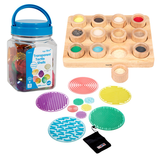Transparent Tactile Shells learning kit with blue carry handle, wooden storage board with 12 textured shells, colorful textured sensory discs, and black storage