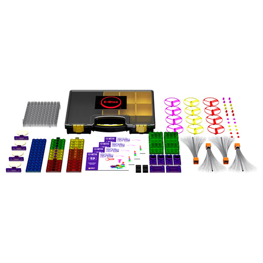 E-Blox Circuit Blox Class Set contents displayed: black carrying case with gold compartments, colorful circuit blocks in blue, green, yellow and red, purple con