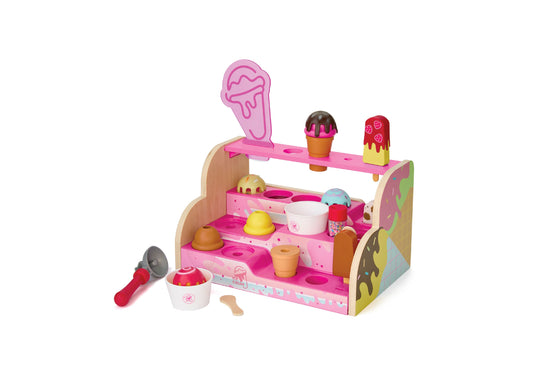 Pink wooden ice cream counter playset with three shelves, ice cream scoop accessories, cones, cups, and decorative ice cream toppings