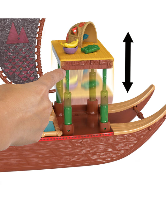 Disney Princess Moana 2 Adventure Canoe Playset modeled by a child's hand, showing red canoe with green support posts, yellow platform with food accessories, an