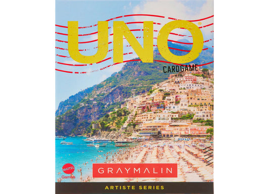 UNO Cardgame Artiste Series by Gray Malin featuring coastal beach village landscape with turquoise water and cliffside buildings