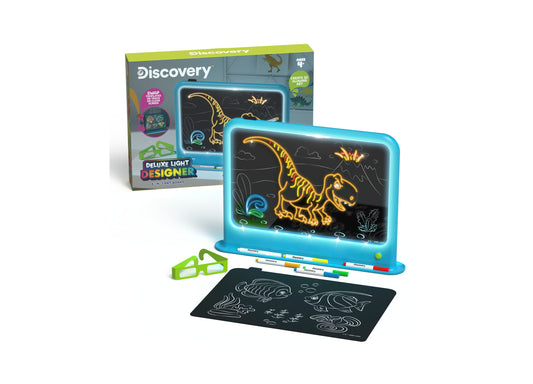 Discovery Kids Deluxe Light Designer 6-in-1 Art Board with blue light-up tablet displaying neon dinosaur drawings, colored markers, black practice pad with sea