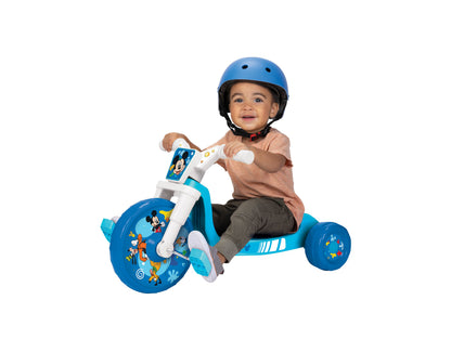 Toddler on blue Mickey Mouse 10" Fly Wheels Cruiser trike wearing blue helmet