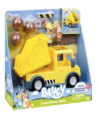 Bluey's Dump Truck set with yellow truck, exclusive hard-hat Bluey figure, muddy Bingo figure, and brown mud pieces
