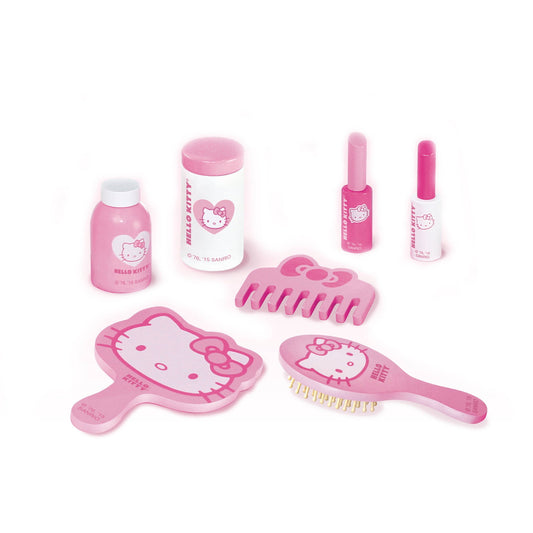 Hello Kitty beauty and grooming playset with pink bottles, containers, hair brush, comb, and mirror on plain background